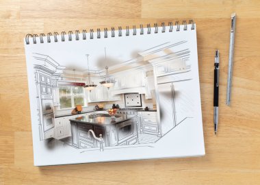 Sketch Pad on Desk with Drawing of Custom Kitchen and Brush Stroke Showing Finished Construction Next To Engineering Pencil and Ruler Scale.