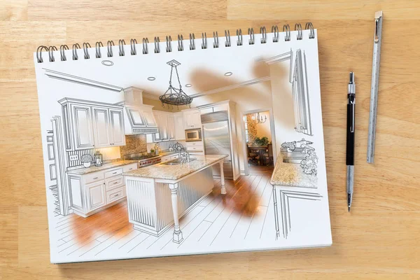 Skizzenblock auf dem Schreibtisch mit Zeichnung von kundenspezifischer Küche und Pinselstrich, der die fertige Konstruktion neben Bleistift und Lineal zeigt. — Stockfoto