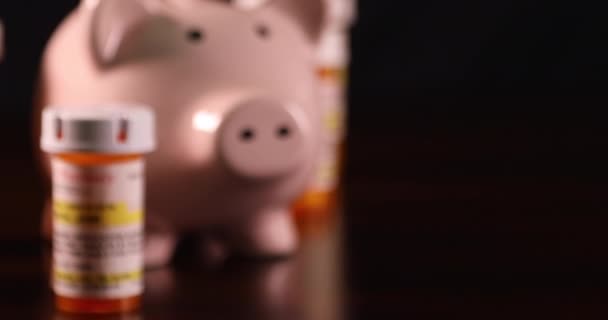 Piggy Bank Non Proprietary Medicine Bottles Dark Wood Surface — стокове відео