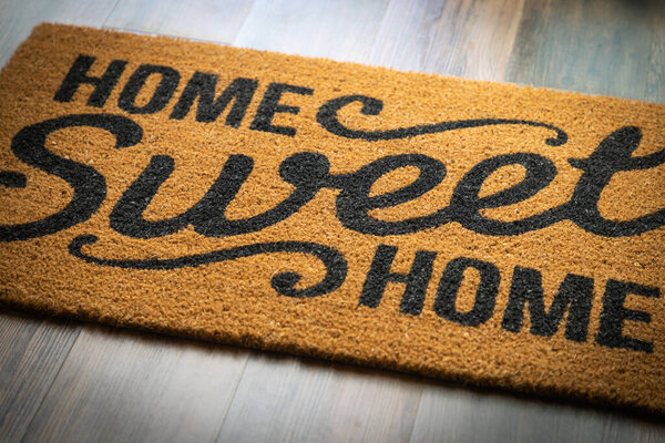 Home Sweet Home Welcome Mat Resting on Floor.