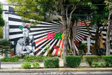 Street art with a painting of Frida Kahlo in Mexico City clipart