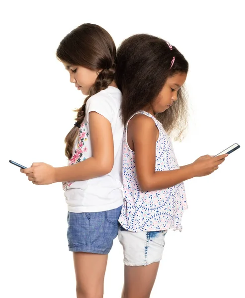 Two Small Girls Addicted Smartphones Ignoring Each Other Isolated White — Stock Photo, Image