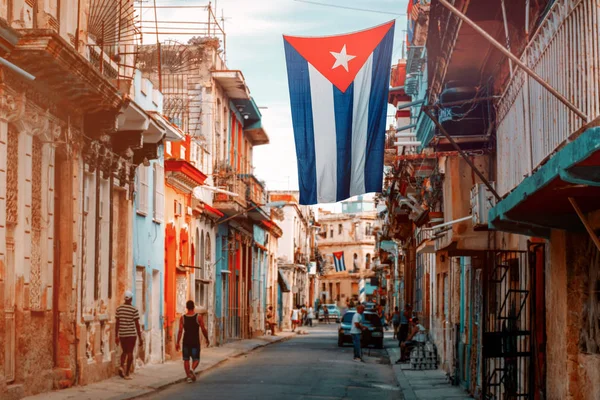 Bandeiras cubanas, pessoas e edifícios envelhecidos em Havana Velha — Fotografia de Stock