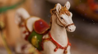 Gelecek sezon için Noel süslemesi. Havada süzülen eski oyuncak at ve parıltılar 