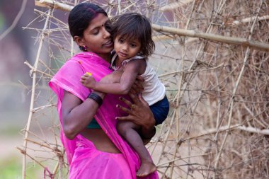 Hindistan 'ın Madhya Pradesh kentindeki Bandhavgarh Milli Parkı' nda, Tala adında küçük bir köyde çocuğuyla birlikte tanımlanamayan bir kadın.