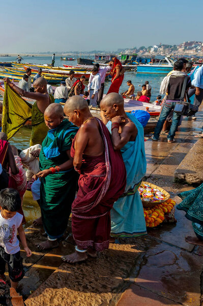 Индия, Варанаси - 23 апреля 2011 года: Неизвестные принимают ритуальные ванны в реке Ганга. Святая ритуальная баня проводится каждый день