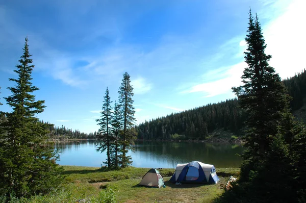 Tent camping by lake in wilderness for recreation purposes