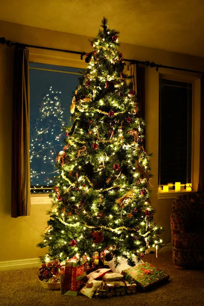 Christmas tree in living room with lights and decorations