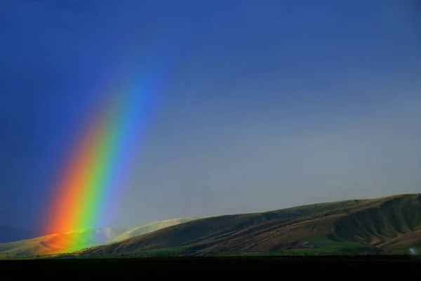 Rainbow in Rain Storm Mountains Landscape