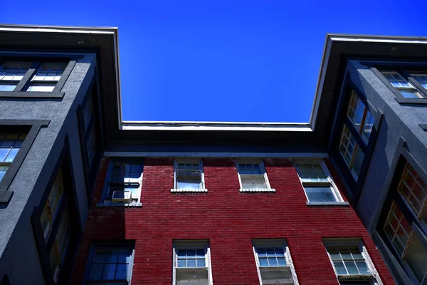 Apartment building flat rental living space with red brick and blue sky