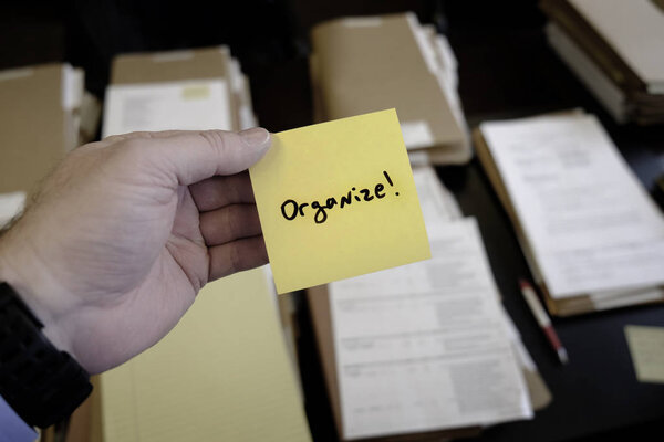 Sticky Note in Hand Businessman Desk Files Folder Working Message Motivation Organize