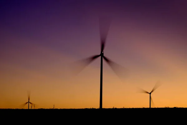 Éolienne éolienne tournant dans le vent au coucher ou au lever du soleil — Photo