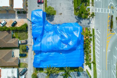 Aerial image of a building with blue fumigation tent clipart