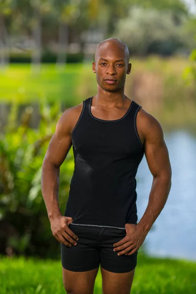 Portrait of a bald fitness model posing in a tank top t-shirt ou — Stock Photo, Image