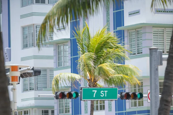 Miami Beach 7th Street road sign with palm trees and hotels in b — Stock Photo, Image