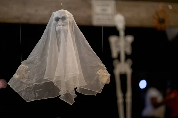 Hanging spooky ghost prop blurry skeleton in background — Stock Photo, Image