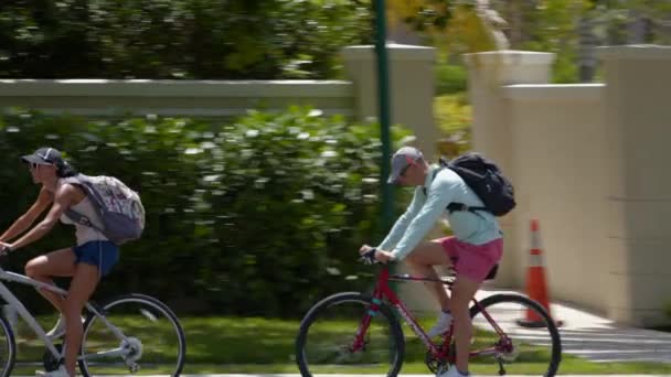 Tracking Shot Adults Riding Bikes Backpacks Shot Blackmagic Raw — Stock Video