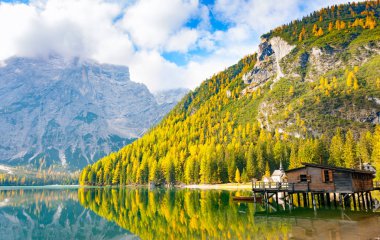 Hut on Prags lake and Dolomites in autumn, Trentino Alto Adige, Italy clipart