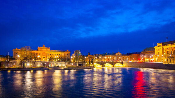 Night view of swedish Parliament House and Riksplan in Helgeandsholmen and Norrbro to Norrmalm, Stockholm, Sweden, Europe