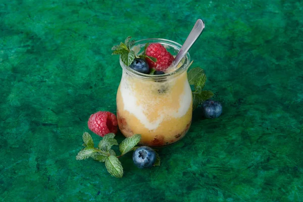 Fresh Smoothie Mango Yougurt Blueberry Raspberries Green Background — Stock Photo, Image