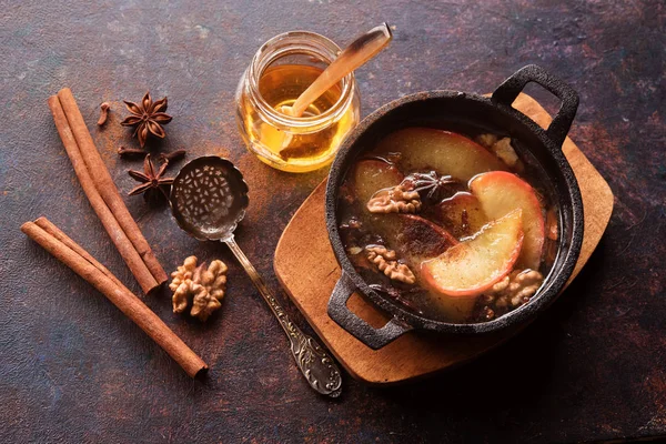 Baked apples with honey, flavored with anise, nuts, cinnamon and nuts