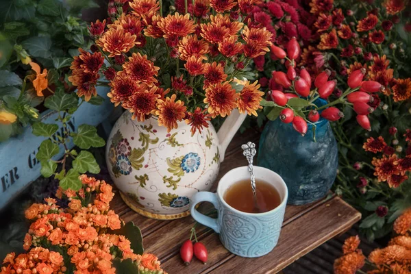 Autumn flowers with cup of tea, thanksgiving decor