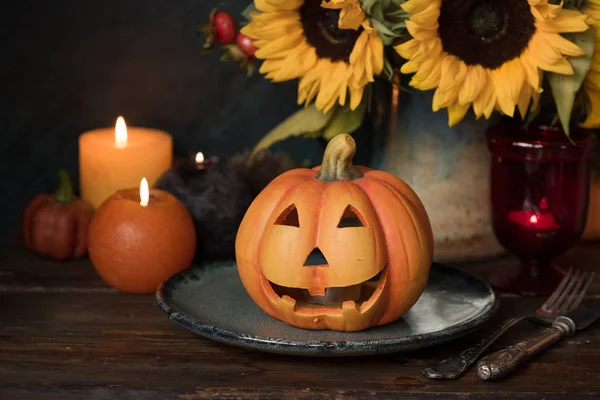 Halloween pompoen decor met kaars en bloemen — Stockfoto