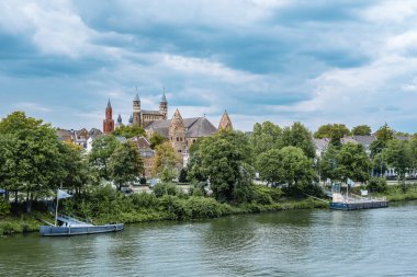 MAASTRICHT, NETHERLANDS 13 Ağustos 2019: Meuse nehrinin kıyısından Basilica Saint Servatius 'a ve Maastricht' teki Meryem Ana Bazilikası 'na.
