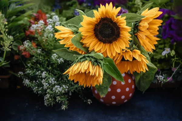 Beautiful sunflowers in the vase on the table