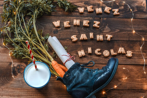 Holiday background Saint Nicholas. There wrote in french- Come Come Saint Nicolas. Children put a wishing letter, cookies and milk for Saint Nicholas, shoe with carrots as a gift to St. Nicholas' horse or donkey. 