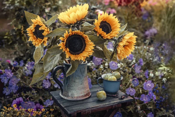 Beautiful summer flowers in the garden, Sunflowers in the vase and fresh fruits