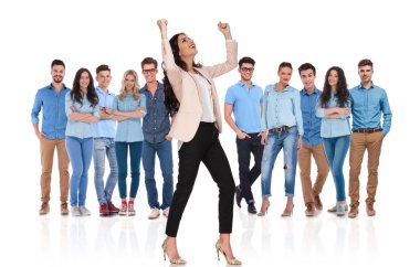Her iki el havada ile kutluyor ve yan ekibi beyaz arka plan önünde dururken isteyen heyecanlı işkadını grup lideri