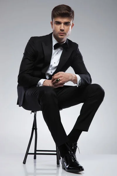 Attractive Seated Stylish Man Black Tuxedo Black Bowtie Light Grey — Stock Photo, Image