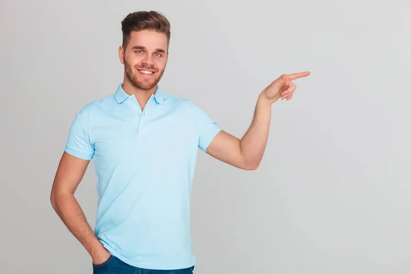 Portrait Smiling Relaxed Man Wearing Light Blue Polo Shirt Pointing — Stock Photo, Image