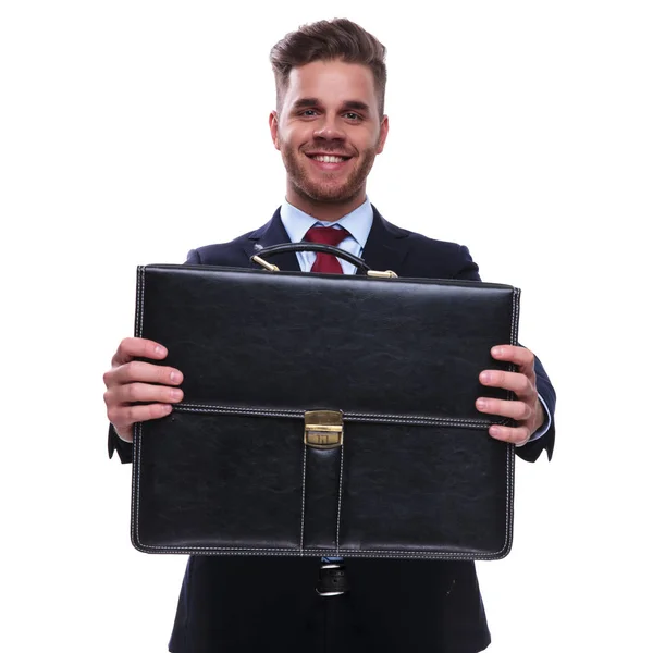 Portrait Smiling Businessman Navy Suit Offering You His Case While — Stock Photo, Image