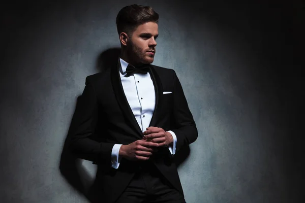 Handsome Unshaved Man Wearing Black Tuxedo Looks Side While Holding — Stock Photo, Image