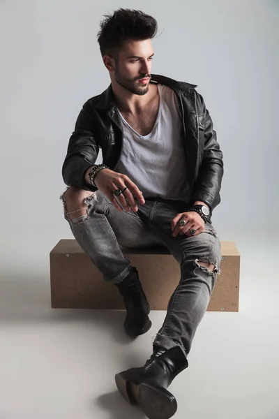 Handsome Man Wearing Black Leather Jacket Looks Side While Sitting — Stock Photo, Image