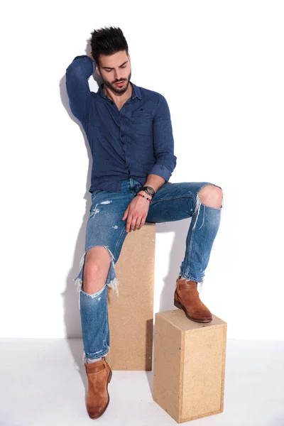 Casual Man Navy Shirt Ripped Jeans Rests Wooden Boxes Arranges — Stock Photo, Image