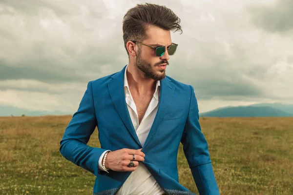 Attractive Smart Casual Man Sunglasses Buttoning Blue Suit Looking Side — Stock Photo, Image