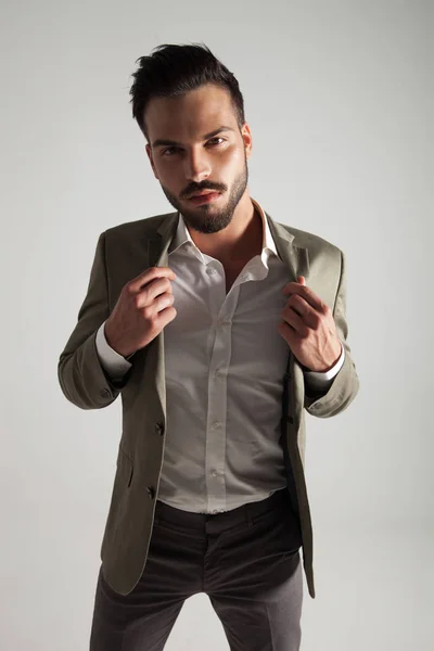 Seductive Elegant Man Holds His Green Suit Collar While Standing — Stock Photo, Image