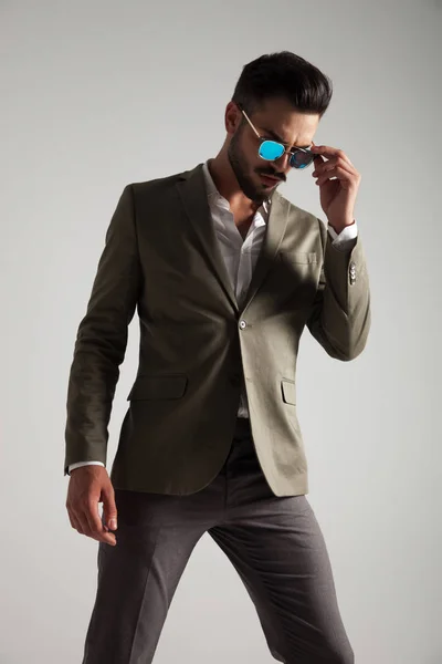 Portrait Stylish Man Fixing Sunglasses Looking While Standing Light Grey — Stock Photo, Image