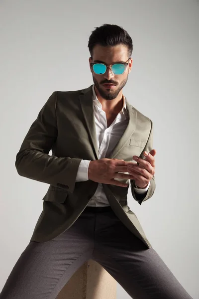 Sexy Stylish Man Wearing Sunglasses Sits Wooden Box Light Grey — Stock Photo, Image