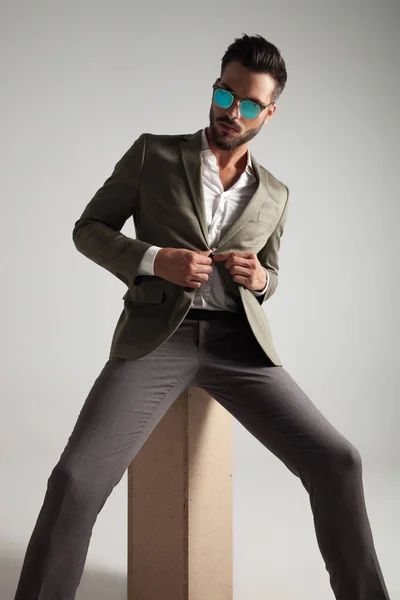 Handsome Man Sunglasses Buttoning His Green Suit Looking Side While — Stock Photo, Image