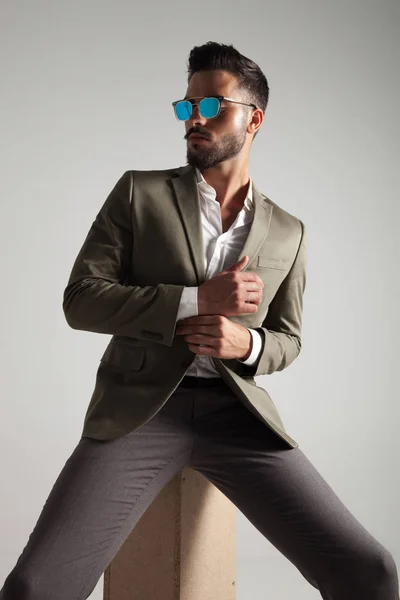 Stylish Man Green Suit Sunglasses Arranges His Cuffs Looks Side — Stock Photo, Image