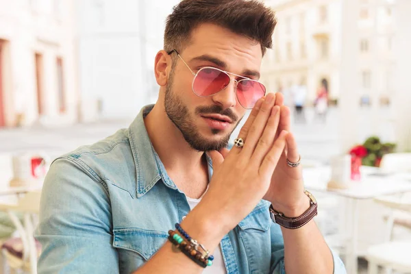 Young Man Sunglasses Holding Palms Together While Sitting City Daylight — Stock Photo, Image