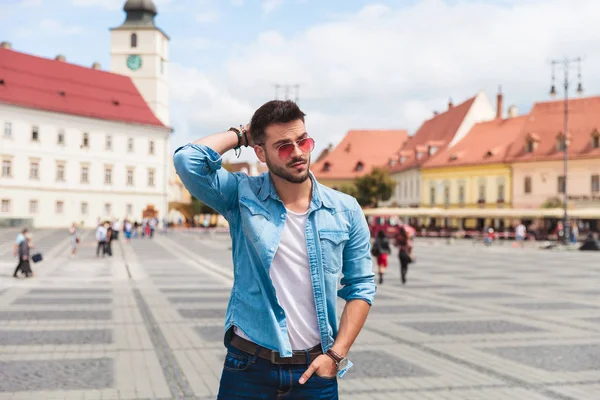 Relaxed Handsome Man Wearing Sunglasses Holding His Neck Looks Side — Stock Photo, Image