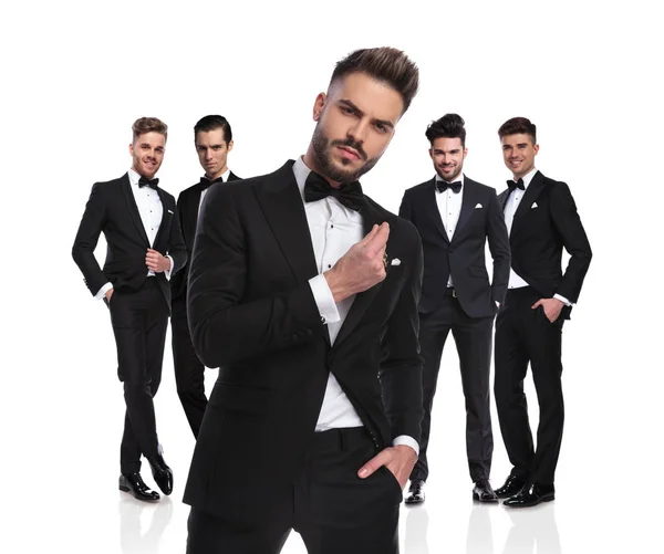 Five Elegant Groomsmen Standing White Background Dressed Black Tuxedoes Arrogant — Stock Photo, Image