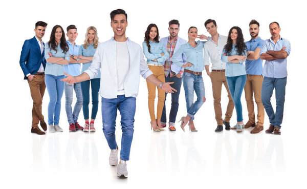 casual group leader welcomes you with open hands in his team while standing on white background, full body picture