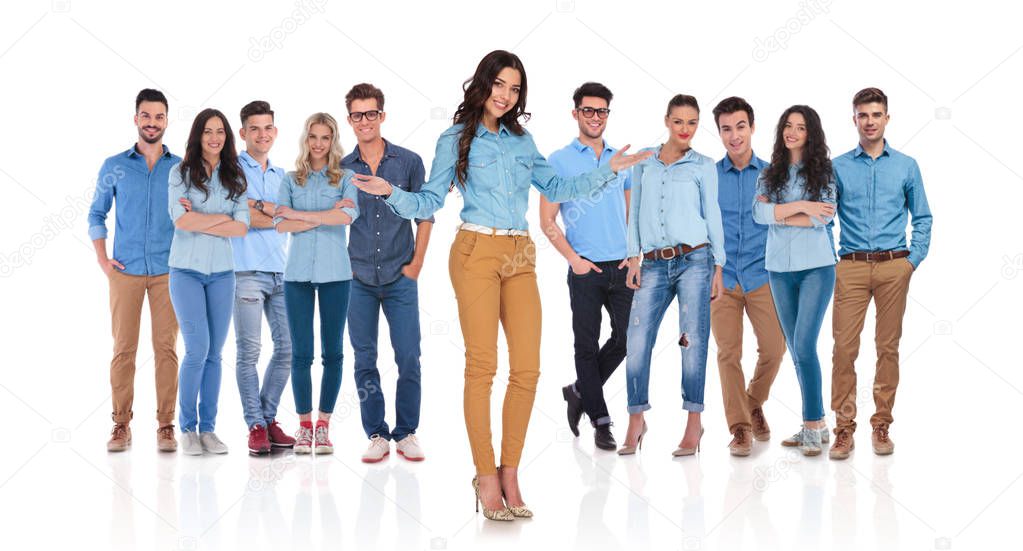 casual woman leader greeting you in her team with both hands while standing on white background in front