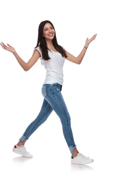 Joyful Woman Wearing White Shirt Walking Side While Raising Hands — Stock Photo, Image